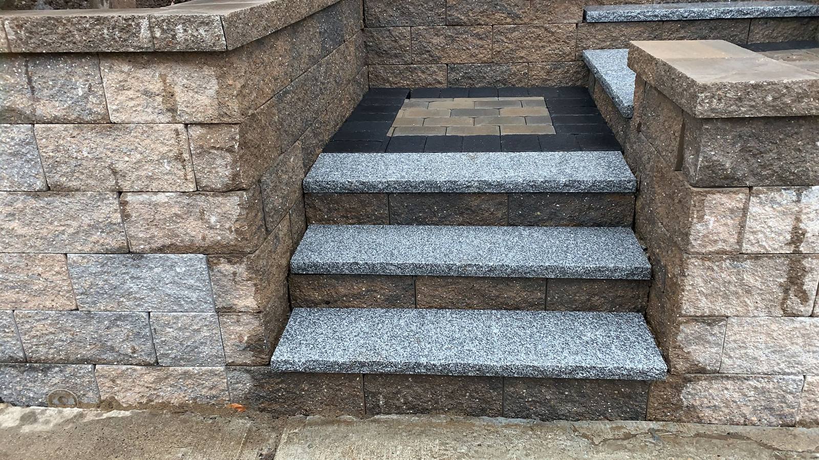 Custom granite and paver stonework detail by WR Ferreira in Massachusetts